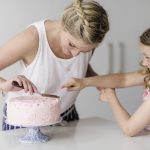 Mom & Daughter icing a cake