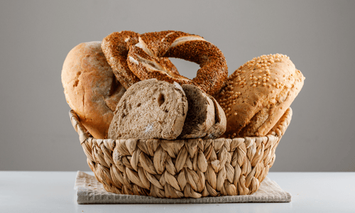 Sliced bread with turkish bagel side view on a white and gray surface.